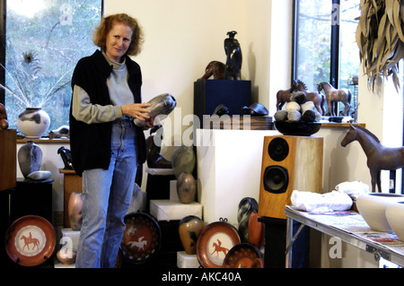 Potter showing work in studio Stock Photo