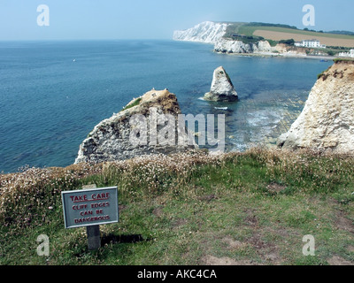 Cliff edge warning sign on top of soft chalk cliffs along Freshwater Bay Isle of Wight Stock Photo