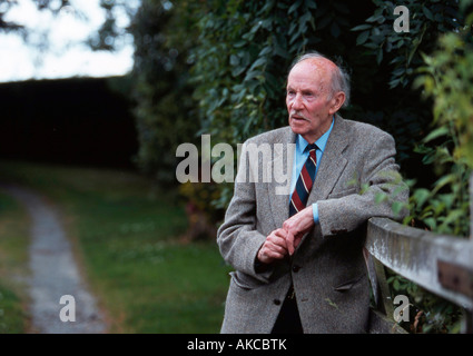 Elderly man leaning on a fence Stock Photo