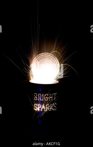 Bright sparks. Punched holes in a Tin can and a firework at night on a long exposure Stock Photo