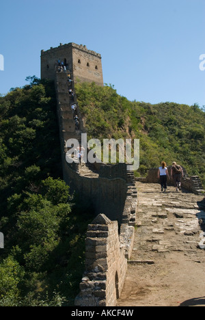 Walkers confront an extremely steep staircase on the Great Wall of China. Stock Photo