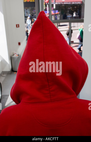 Young man wearing a red hoodie, hoody on escalator, Boston, Massachusetts, USA Stock Photo