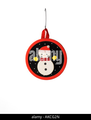 Vintage Christmas ornament decoration of handmade snowman night scene hanging on hook Stock Photo