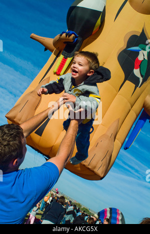 Young boy being thrown into air by father Stock Photo