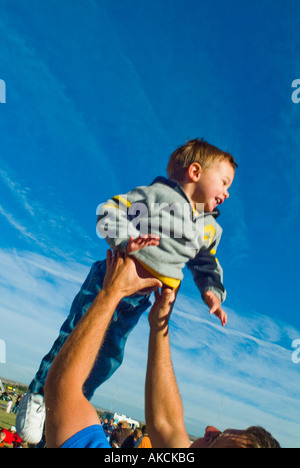 Young boy being thrown into air by father Stock Photo