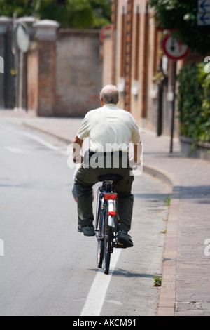 Man riding bicycle on the island of Lido Venice Italy Stock Photo