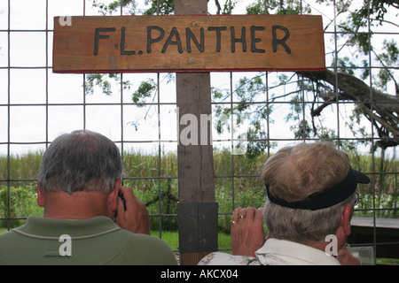 Florida US 27,Everglades,Sawgrass Recreational Park,live panther exhibit exhibition,men,fence,information,broadcast,publish,message,advertise,visitors Stock Photo