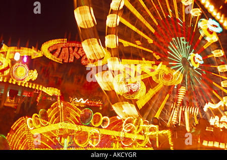 fair with lightened racing amusement ferries wheel rides in different ...