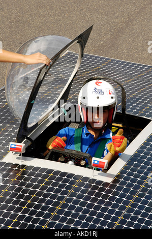 Pilot of a solar racing car. This vehicle uses photovoltaik technology to convert sunshine into energy through its solar panels. Stock Photo