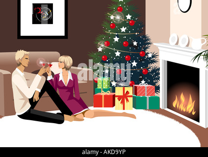 Couple toasting with glasses of red wine near a Christmas tree Stock Photo