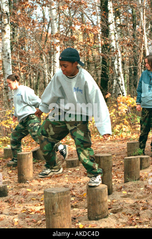 Multiethnic teens participating in obstacle course. Camp Ripley Minnesota USA Stock Photo