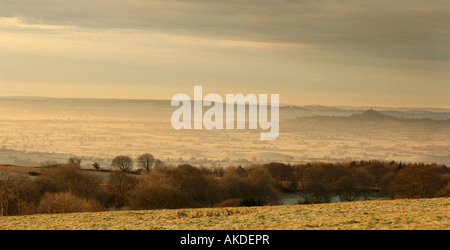 A landscape view of early morning mist rising off the Somerset Levels near the city of Wells, England. Stock Photo