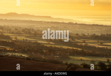 A landscape view of early morning mist rising off the Somerset Levels near the city of Wells, England. Stock Photo