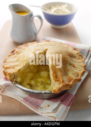 A whole open apple pie with custard and thick double cream editorial food Stock Photo