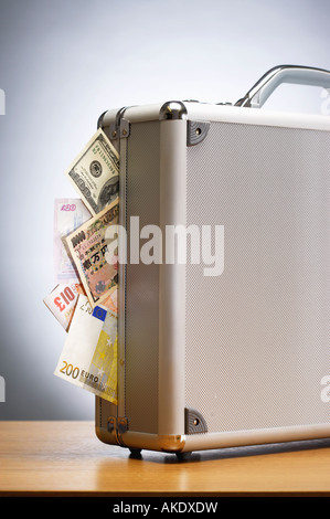 Metal briefcase full of cash on table Stock Photo