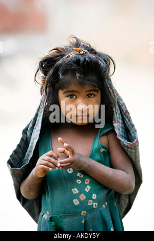 Poor indian street girl carrying a bag on her head, Andhra Pradesh, India. Selective focus Stock Photo