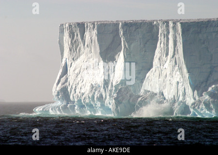 Large square iceberg in the Southern Ocean calving on a calm sea in the Southern Ocean,Antarctica, Stock Photo