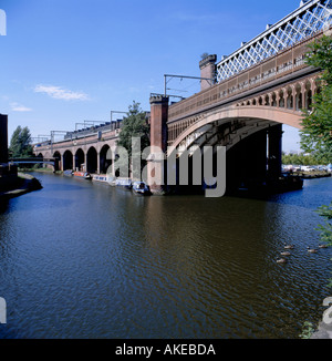 Cast iron arch railway bridge over the Duke of Bridgewater's Canal, Castlefield Urban Heritage Park, Manchester, England, UK. Stock Photo