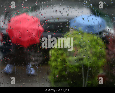 Coloured umbrellas, seen through the window. Stock Photo