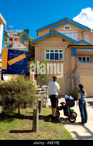 A family standing outside their new home Stock Photo - Alamy