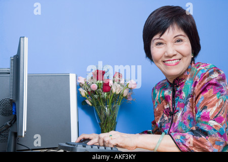Portrait of a senior woman using a computer and smiling Stock Photo