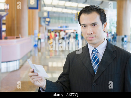 Portrait of a businessman holding an airplane ticket Stock Photo