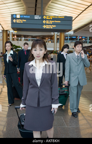 Business executives leaving an airport Stock Photo