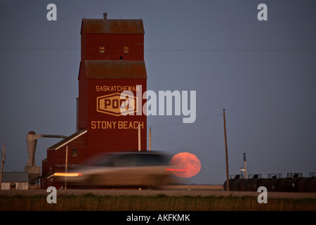 Full moon rising near Stoney Beach grain elevator Stock Photo
