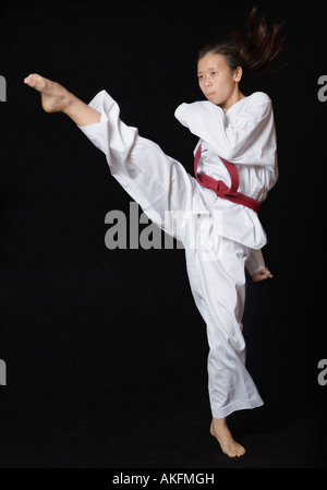 Young woman performing round kick Stock Photo