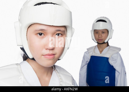 Portrait of a young woman wearing a sports helmet with another young woman standing in the background Stock Photo