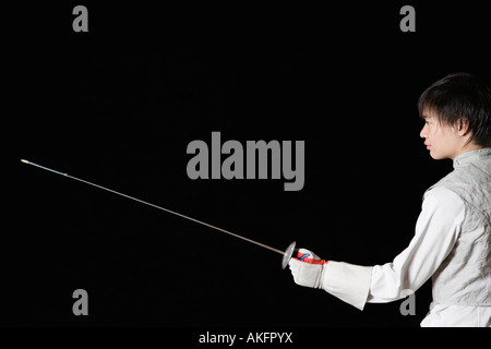 Male fencer holding a fencing foil Stock Photo