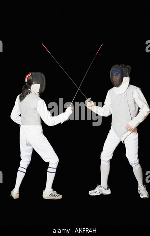 Man and a woman fencing Stock Photo