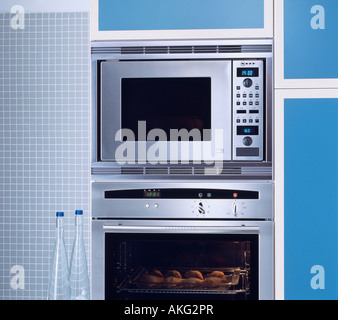 Close up of stainless steel microwave oven in modern blue kitchen Stock Photo
