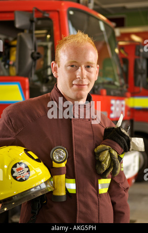 Portrait of London Fire Brigade fireman Dan Savva in front of fire trucks. Stock Photo