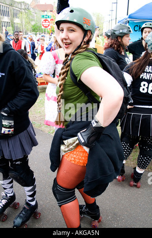 Feisty Minnesota RollerGirl age 22 in uniform and showing a little hip. MayDay Parade and Festival. Minneapolis Minnesota USA Stock Photo