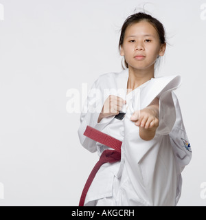 Portrait of a young woman performing front kick Stock Photo