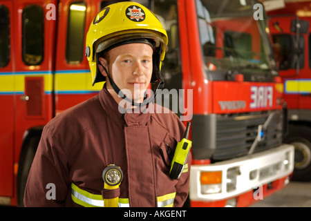 Portrait of London Fire Brigade fireman in front of fire trucks. Stock Photo