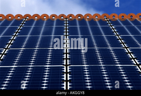 Photovoltaic cells (solar panels) on the roof of a house to produce electricity. Stock Photo