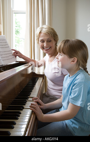Girl and grandmother playing piano Stock Photo