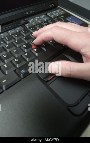 qwerty computer keyboard being used on a black laptop uk Stock Photo