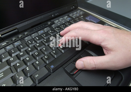 qwerty computer keyboard being used on a black laptop uk Stock Photo