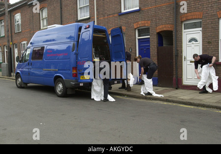 Police officers prepare to examine a crime scene UK Stock Photo