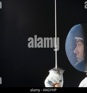 Close-up of a male fencer holding a fencing foil Stock Photo