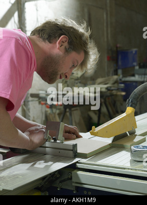 Carpenter using table saw Stock Photo