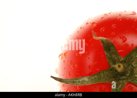 close up of tomato with waterdrops strong backlit shallow DOF Stock Photo