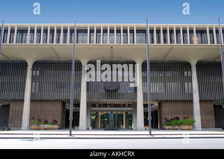 Front of the Hawaii state capitol building or state house in Honolulu with statue of Father Damien and bronze state seal Stock Photo