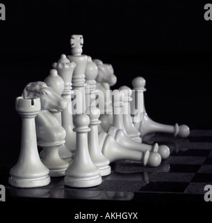 A 0164 white chess pieces with three fallen pawns Stock Photo