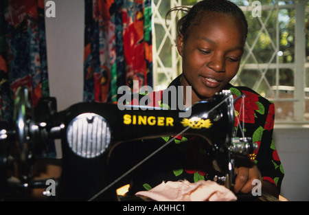 A young woman using a sewing machine, Harare, Zimbabwe Stock Photo