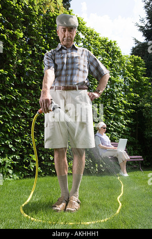 Man watering lawn Stock Photo