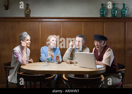 Senior adult with different technologies Stock Photo